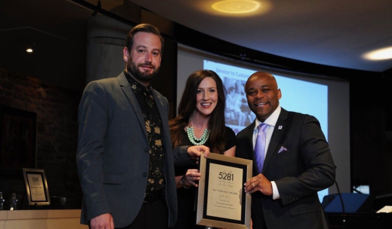 Julian Wolff receiving a 2019 recognition from Mayor Michael B. Hancock for delivering free and low-cost animal support services at Denver Animal Protection.
