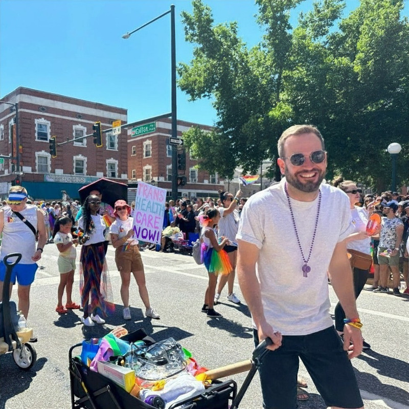 Julian Wolff at the Denver Pride parade, pulling a wagon along the route.