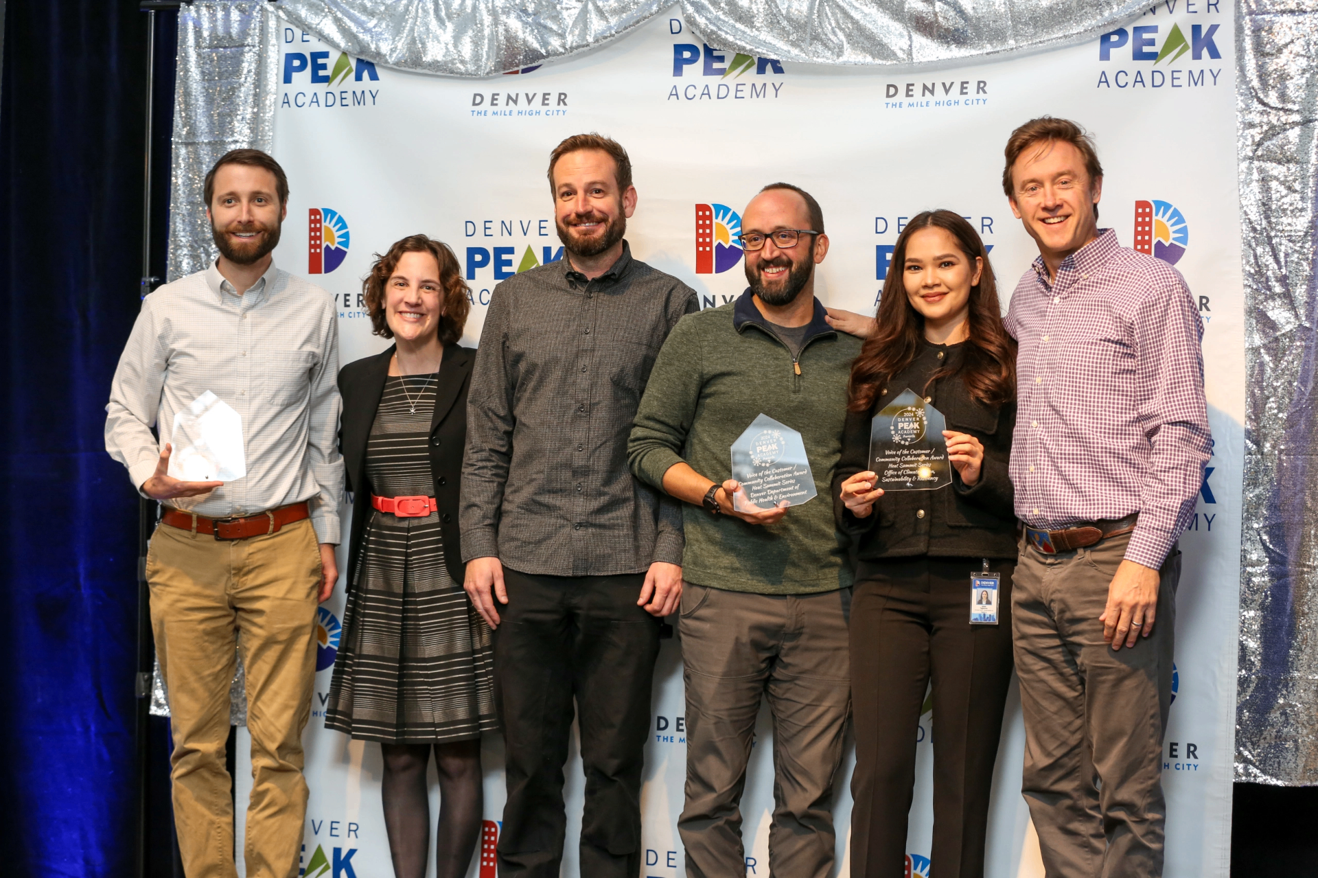 Julian Wolff and the Denver Department of Public Health and Environment team accepting a Voice of the Customer / Community Collaboration Award for the Heat Summit Series.